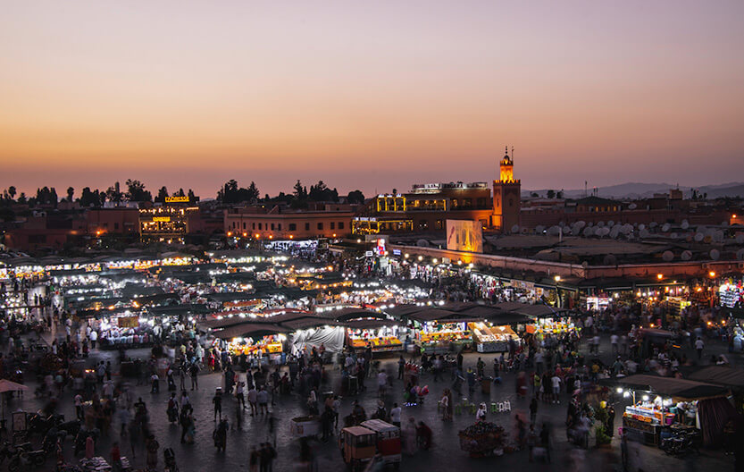 How beautiful the city is at sunset! We’re sitting on a rooftop terrace, watching the sun set over Jemaa el-Fna.