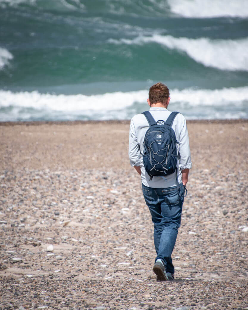 Peter walking on the beach at Svinkløv Badehotel.