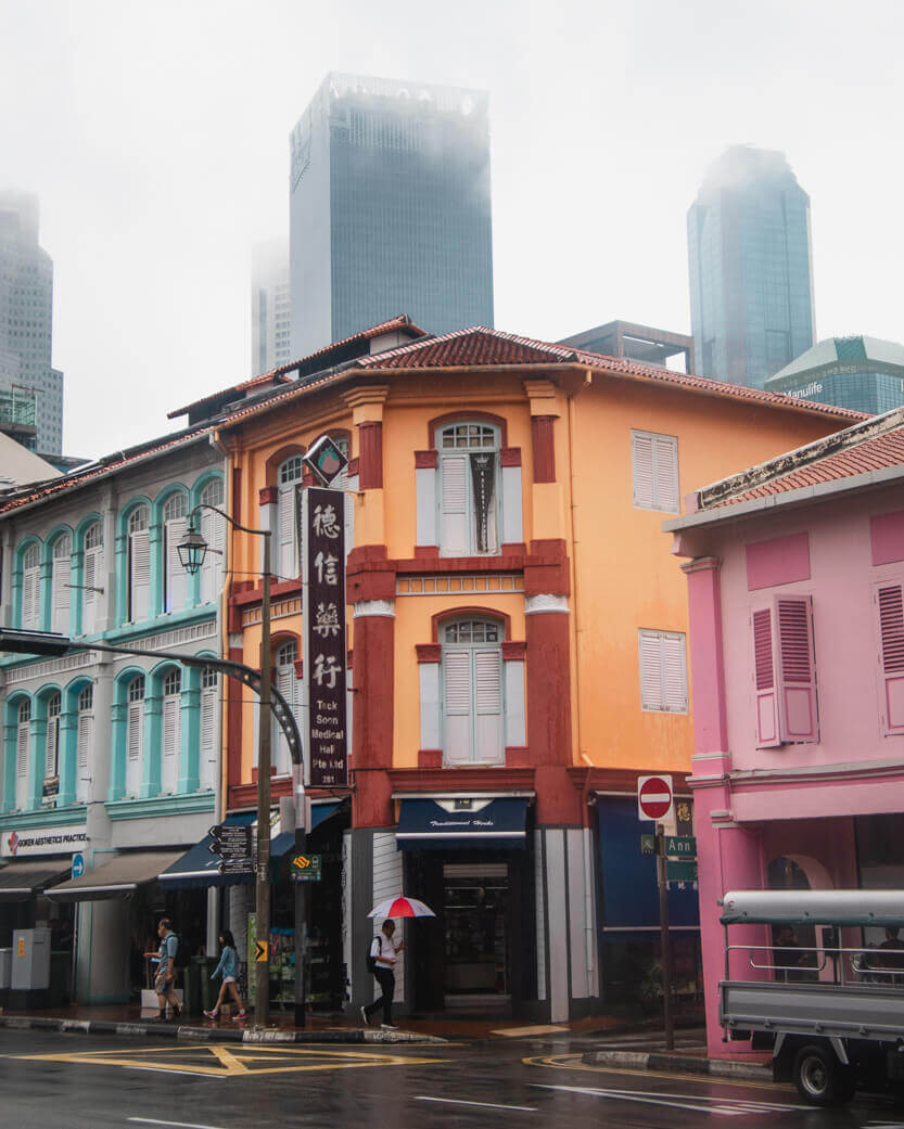 Old Chinese shophouses with the Business District skyscrapers in the background.