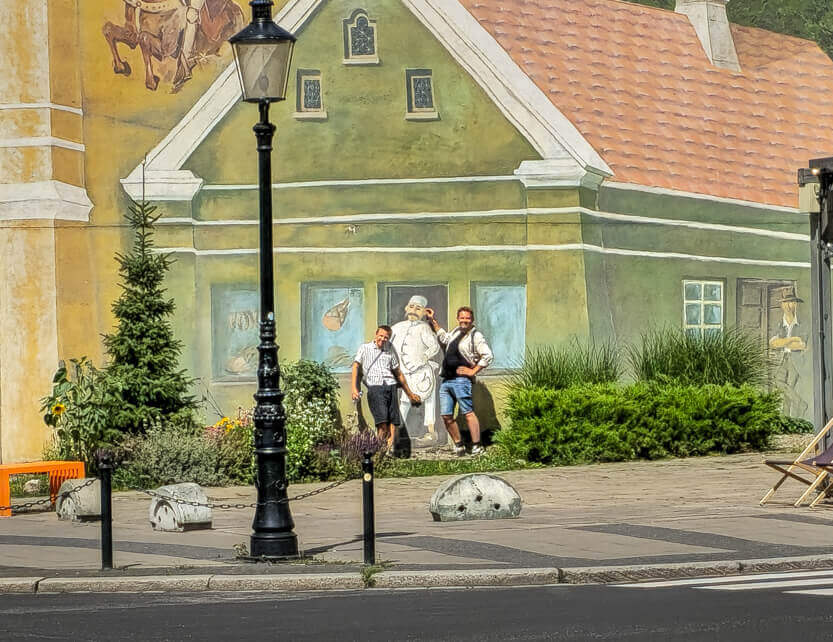 Peter and Sebastian in front of the wall painting in Srodka, Poznan